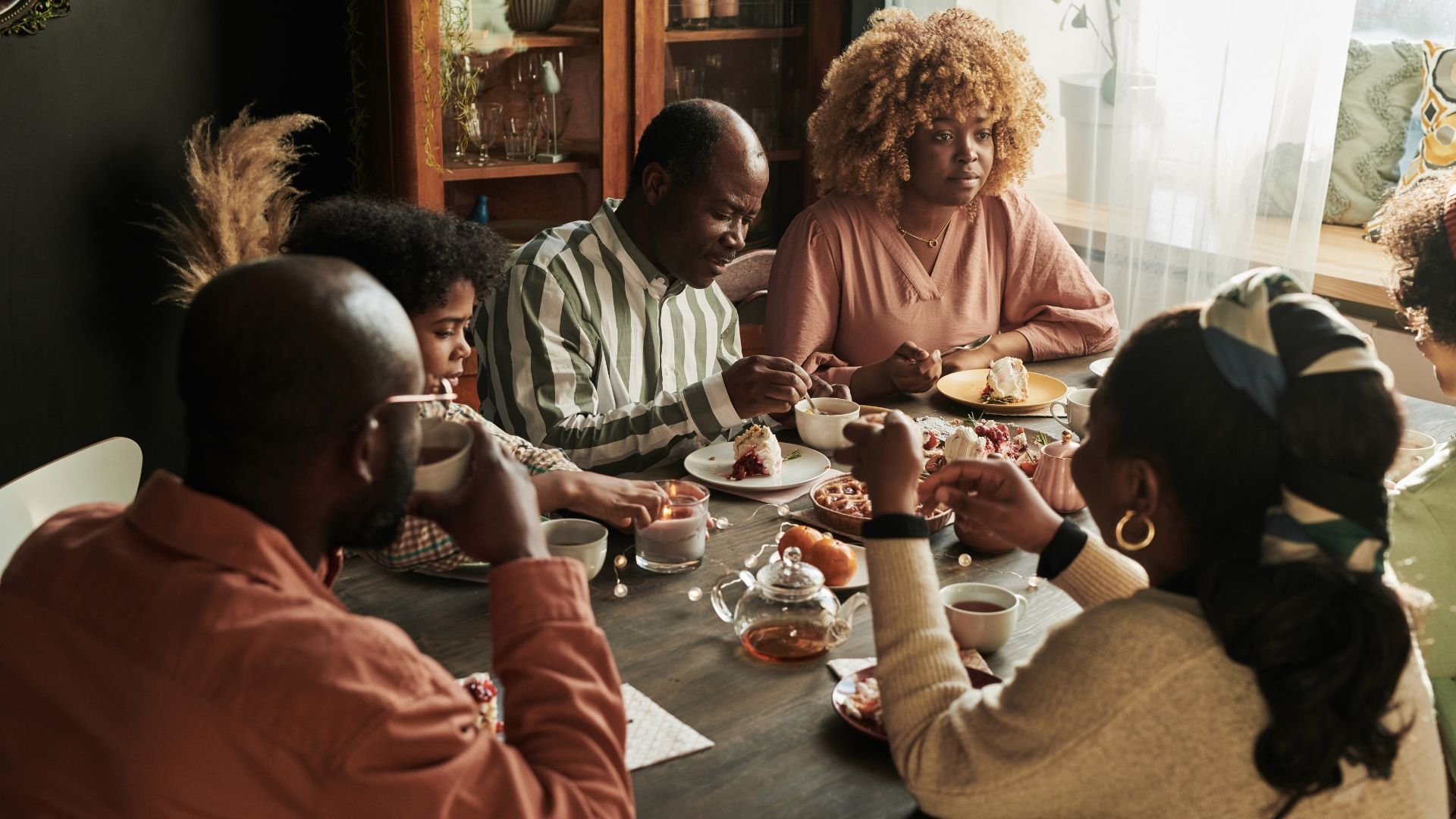 Multiple generations of a family gathered around a dining table